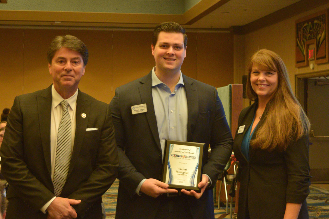 Michael, Mitchell, and Gina Alvarez accepting plaque at chamber luncheon